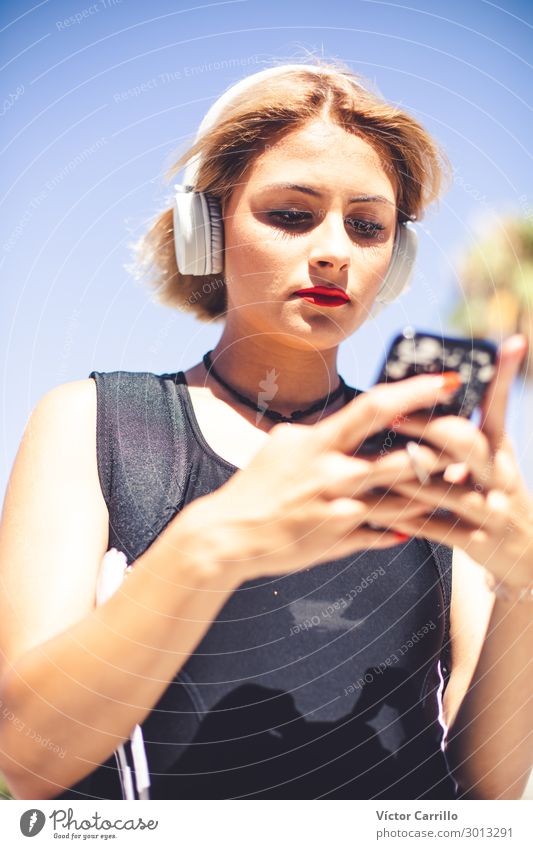 A blonde young girl with an electronic device Lifestyle Human being Feminine Young woman Youth (Young adults) 1 18 - 30 years Adults To call someone (telephone)