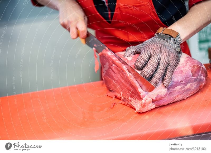 Woman cutting fresh meat in a butcher shop Food Meat Shopping Work and employment Profession Business Human being Adults Hand 1 30 - 45 years Fresh Red White