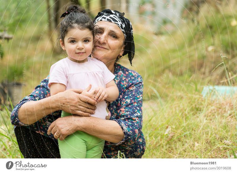 Muslim senor grandmother embraced her little grandchild at garden Lifestyle Happy Healthy Wellness Vacation & Travel Garden Child Feminine Girl Woman