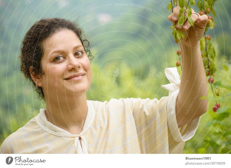 Portrait of a happy young woman holding a plum branches Fruit Lifestyle Joy Happy Beautiful Healthy Eating Well-being Calm Leisure and hobbies Summer Garden