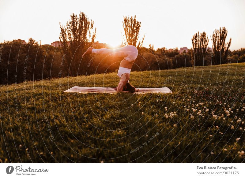 young beautiful asian woman doing yoga in a park at sunset Lifestyle Happy Beautiful Body Harmonious Relaxation Meditation Leisure and hobbies Summer Music