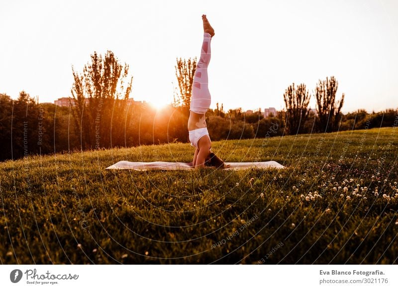 young beautiful asian woman doing yoga in a park at sunset. Lifestyle Happy Beautiful Body Harmonious Relaxation Meditation Summer Music Sports Yoga Human being