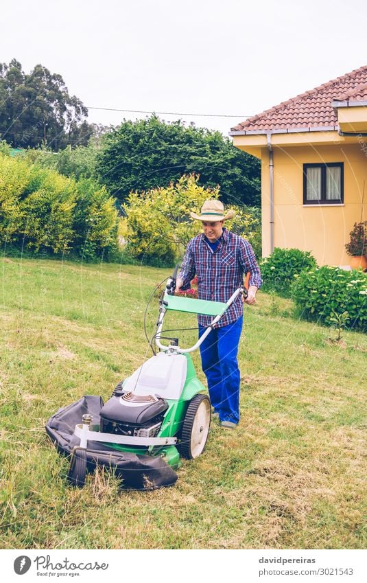 Young man mowing the lawn with lawnmower Summer House (Residential Structure) Garden Work and employment Profession Gardening Tool Engines Technology