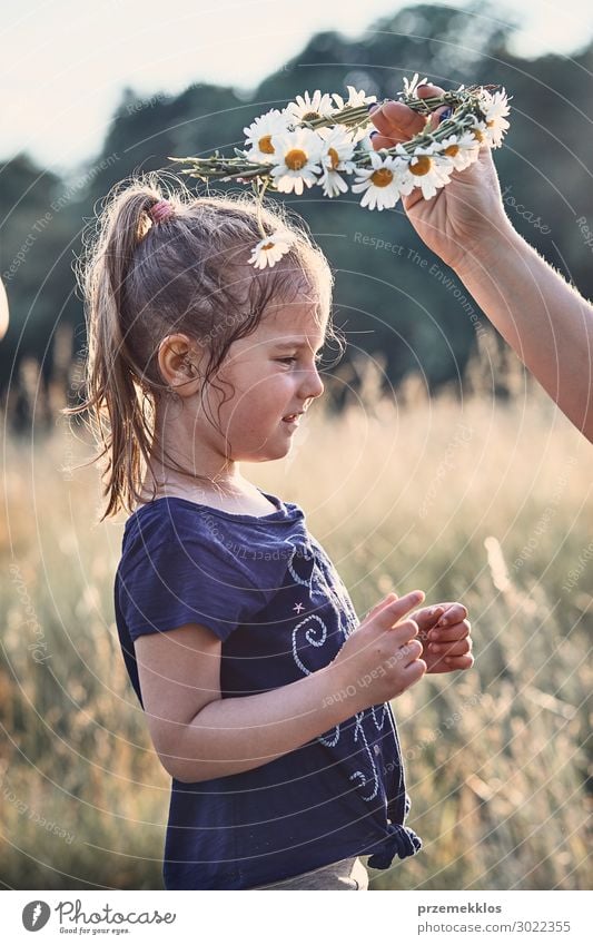 Mother putting a coronet of wild flowers on a head of girl Lifestyle Joy Happy Relaxation Leisure and hobbies Vacation & Travel Summer Summer vacation Child