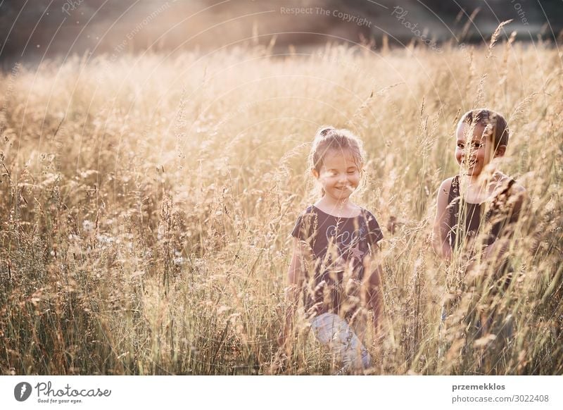 Little happy smiling kids playing in a tall grass Lifestyle Joy Happy Relaxation Vacation & Travel Summer Summer vacation Child Human being Girl Boy (child) Man