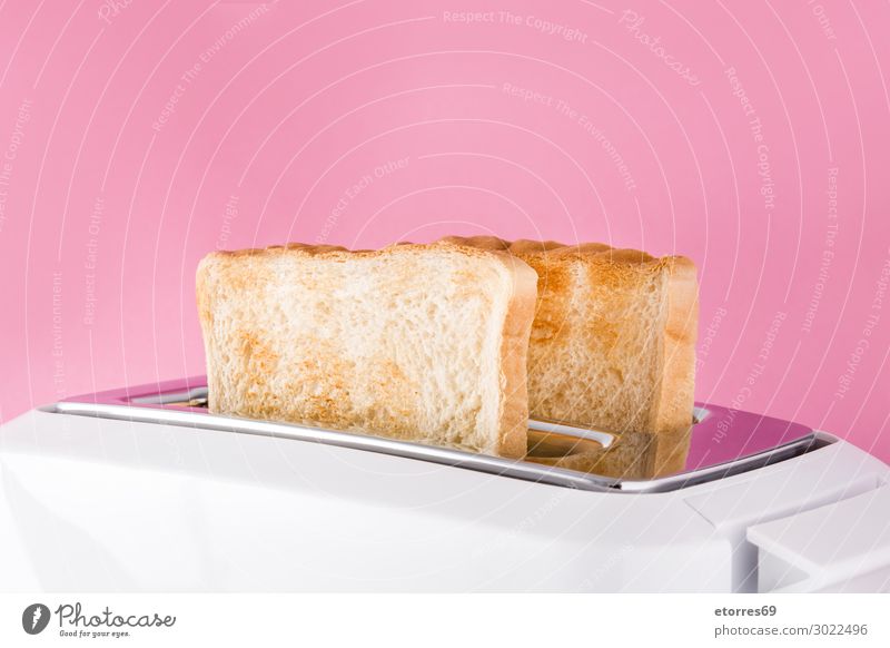 Toasted toast bread in white toaster on pink background. Bread Ready Toaster White isolated Food Healthy Eating Food photograph Breakfast Sandwich Close-up