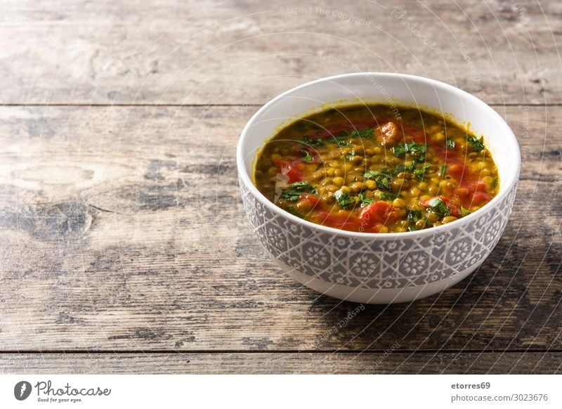 Indian lentil soup dal (dhal) in a bowl on wooden table Lentils Soup Bowl Yellow Food Healthy Eating Food photograph Tradition Spicy diwali Home-made isolated