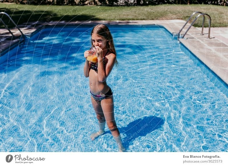beautiful teenager girl at the pool drinking orange juice Drinking Juice Lifestyle Joy Swimming pool Playing Vacation & Travel Summer Sun Sports Dive Child