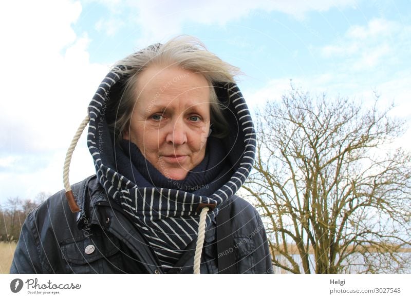 Senior with hooded jacket stands outside in the wind when the weather is fine Human being Feminine Woman Adults Female senior Senior citizen 1