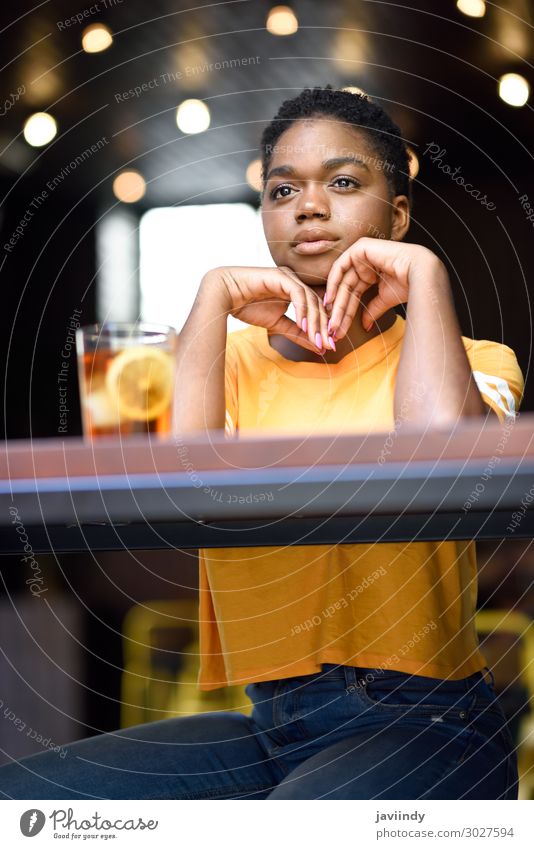 Black woman with very short hair taking a glass of cold tea. Tea Lifestyle Style Happy Beautiful Hair and hairstyles Face Table Restaurant Human being Feminine