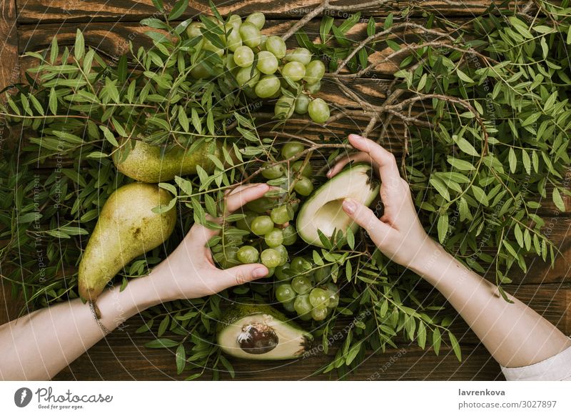 woman's hands holding grapes, pears and avocados Agriculture Avocado Branch Farm Woman flat lay Food Healthy Eating Dish Fresh Fruit Garden Bunch of grapes