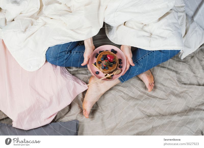 woman in her bed holding plate with pancakes Bed Bedclothes Blueberry Breakfast Woman Food Healthy Eating Dish Food photograph Fresh Hand Jeans Lifestyle