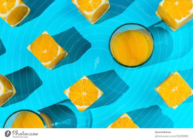 oranges and glasses with juice on blue Glass Juice Orange Blue Bright Citrus fruits Cube Cut Diet flat Food Healthy Eating Food photograph Fruit Geometry