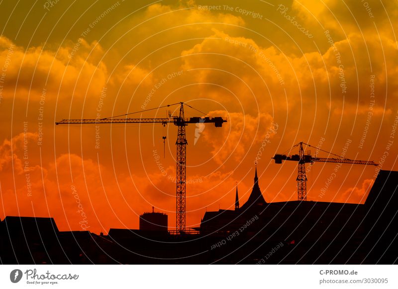 A city can never be finished Rostock Silhouette Construction crane Construction site Sky Clouds Red Haze Work and employment Church spire Day Sunset