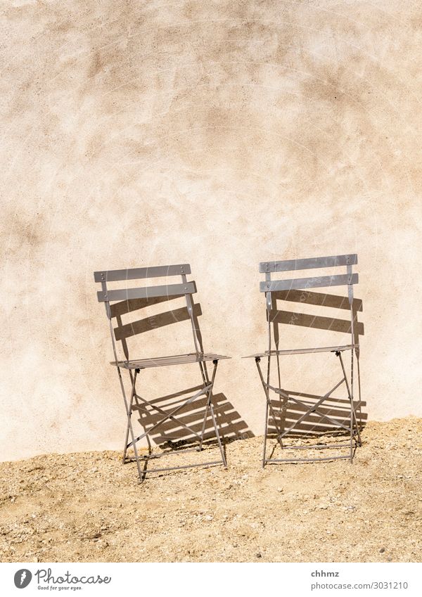 Two chairs Chair house wall bailer Rendered facade metal chair Shadow Shadow play Wall (building) Facade Wall (barrier) Structures and shapes Copy Space top