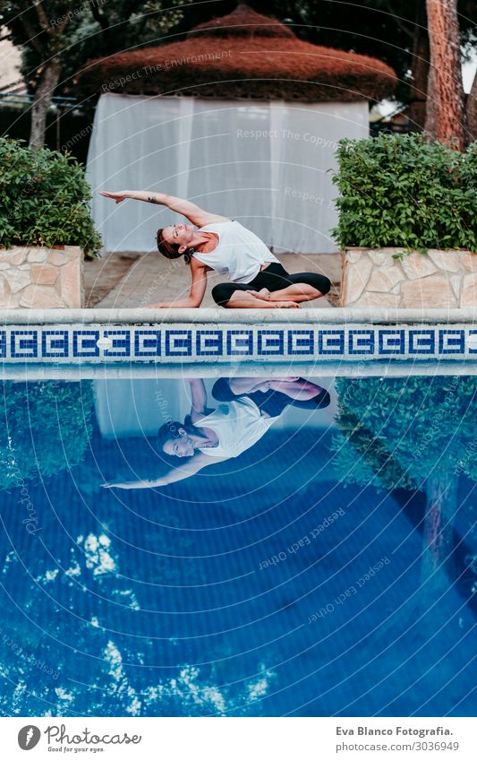 woman doing yoga by swimming pool. Yoga and mindfulness Lifestyle Beautiful Body Relaxation Calm Meditation Spa Swimming pool Vacation & Travel Summer Sun