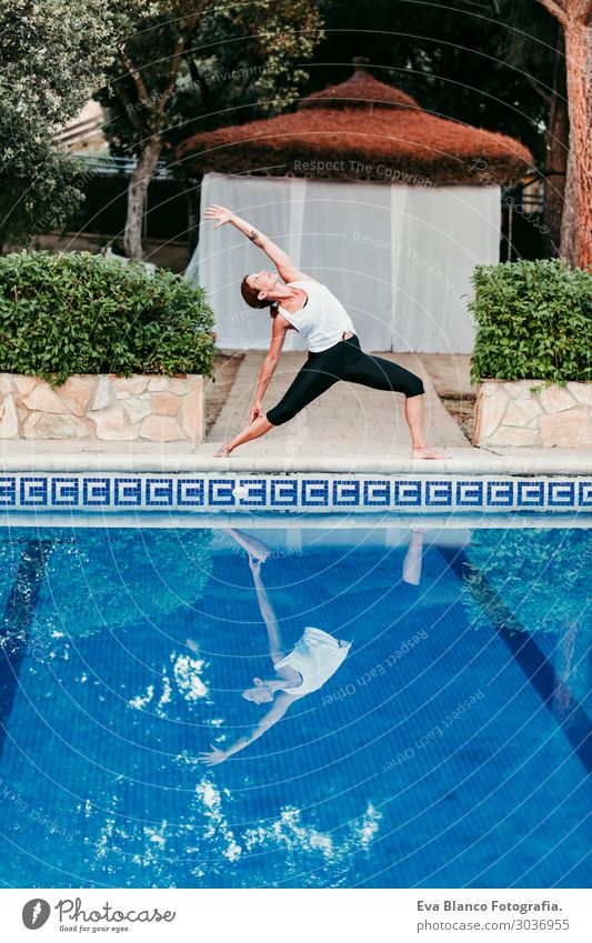 woman doing yoga by swimming pool. Yoga and mindfulness Lifestyle Beautiful Body Relaxation Calm Meditation Spa Swimming pool Vacation & Travel Summer Sun Ocean