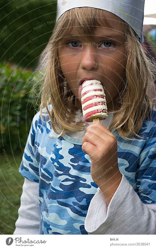 Blonde, long-haired girl with a crown, holding ice cream with curls in her hand and licking it. Birthday party at home in the garden. Food Dessert Candy