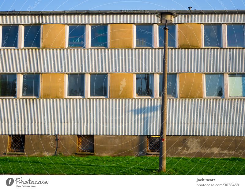 a lot of sunshine in front of the hut GDR Meadow Prenzlauer Berg Building Facade Window Street lighting Corrugated iron wall Stripe Authentic Sharp-edged