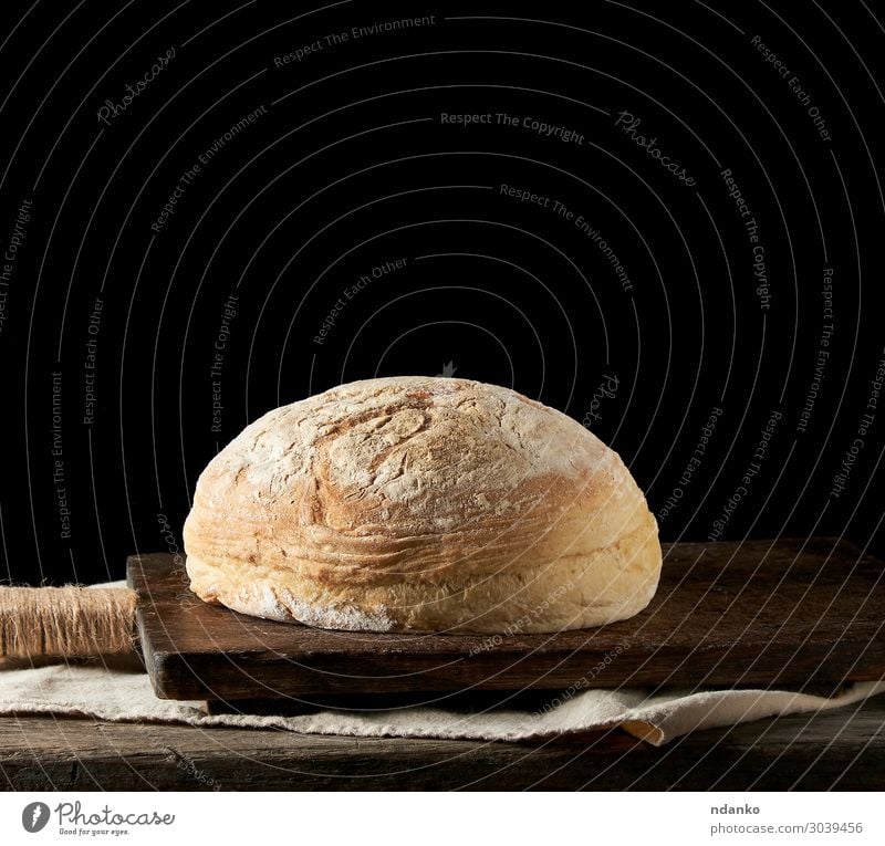 baked round white wheat bread on a textile towel Bread Roll Nutrition Eating Breakfast Dinner Table Kitchen Wood Old Dark Fresh Natural Brown Yellow Black White
