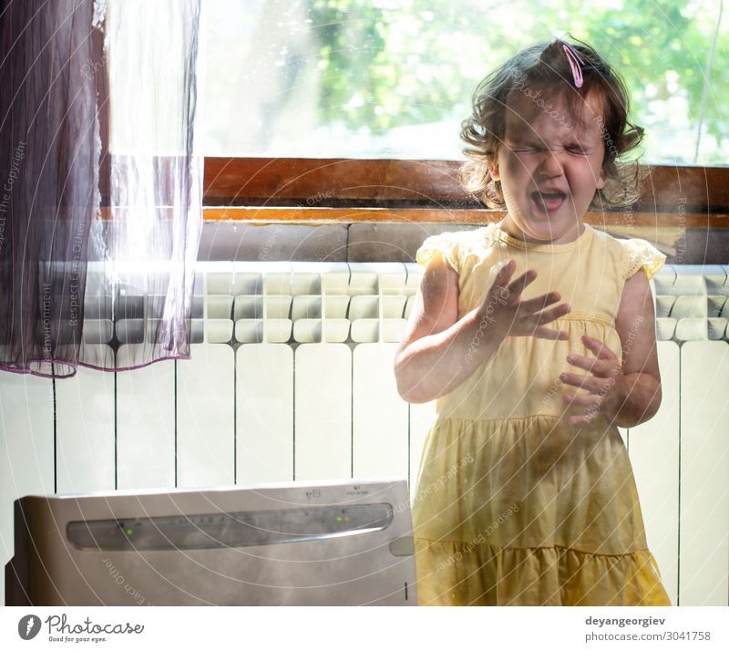 Little girl in a dusty room. Air purifier and coughing kid. Health care Child Infancy Earth Fresh Clean alergy allergen fine dust Sneezing sternutation air Home