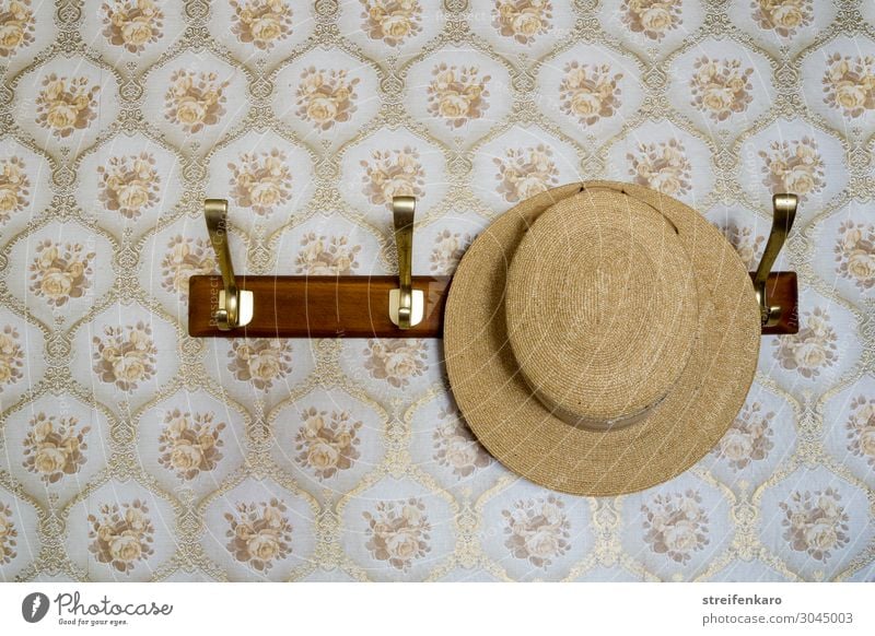 straw hat hangs on coat rack in front of patterned wallpaper Flat (apartment) Hallstand Clothes peg Going out Clothing Hat Wood Feasts & Celebrations