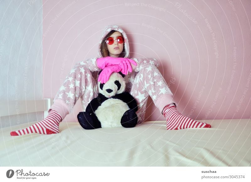 teenager with pink rubber gloves sits on her bed with her cuddly toy and pink sunglasses on Youth (Young adults) Young woman youthful Infancy Goofy Crazy Daft