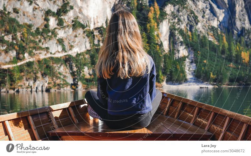 Girl from behind in wooden boat on mountain lake Vacation & Travel Trip Adventure Far-off places Expedition Mountain Hiking Feminine Young woman