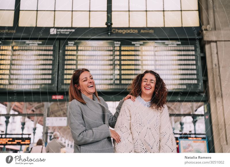 Two beautiful women laughing together at the train station Lifestyle Happy Beautiful Vacation & Travel Tourism Trip Far-off places Woman Adults Friendship