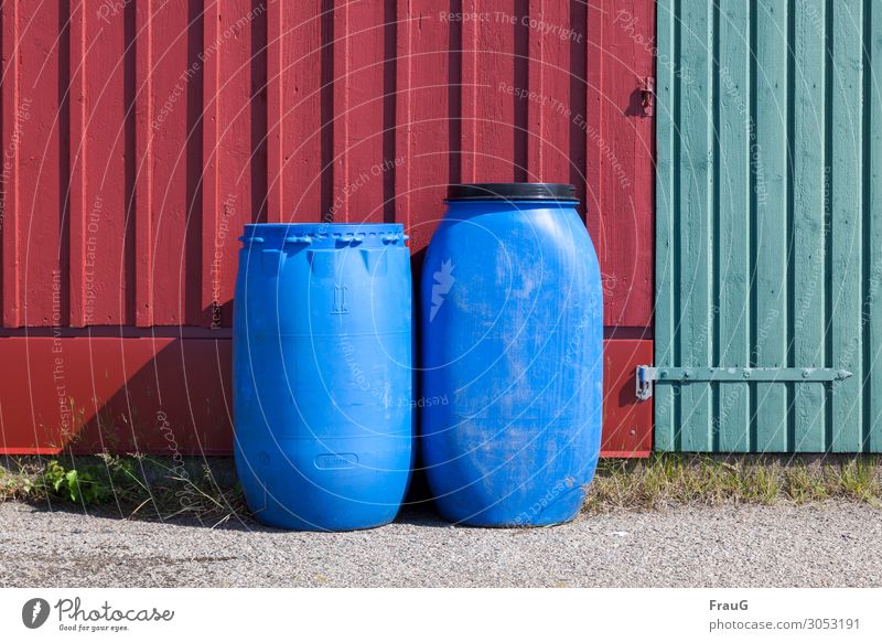 Trapped in plastic. Whatever's inside... Facade Wood Barrels Plastic with lid and without Shadow Deserted Exterior shot Day Green variegated Red Blue
