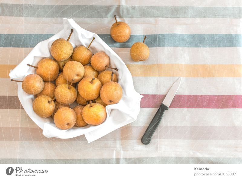 Asian or Nashi pear in a bowl on a colorful tablecloth. Food Vegetable Fruit Nutrition Eating Picnic Organic produce Vegetarian diet Diet Bowl Knives Lifestyle