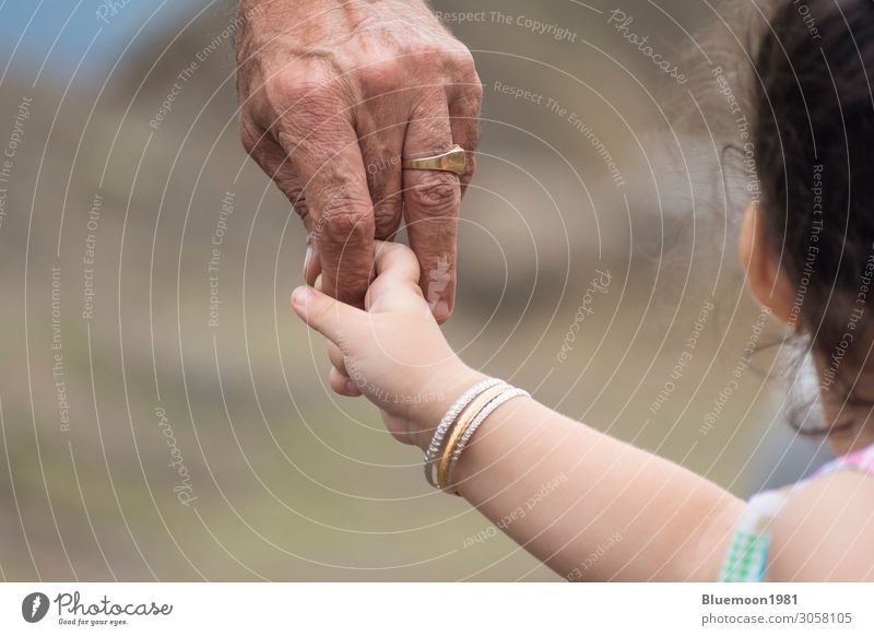 Close-up shot of a child's hand holding finger of his father Lifestyle Skin Vacation & Travel Parenting Child Retirement Masculine Girl Man Adults Parents