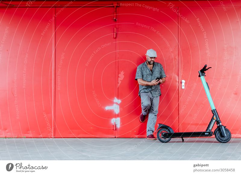 Man in front of red wall with electric scooter Lifestyle Shopping Athletic Masculine Adults 1 Human being 45 - 60 years Means of transport