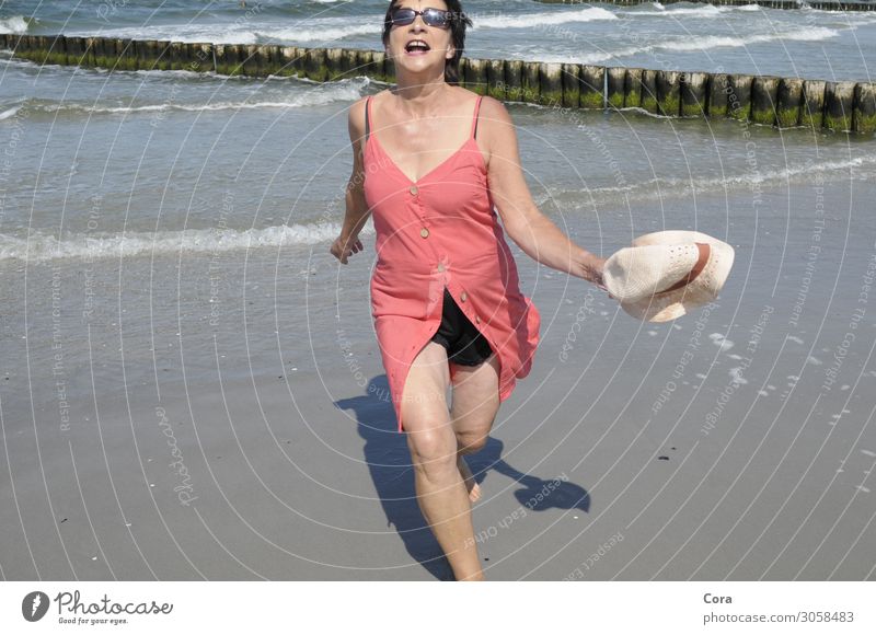 joie de vivre Human being Feminine Woman Adults 1 45 - 60 years Water Summer Baltic Sea Beach Dress Sunglasses Hat Black-haired Movement Relaxation Walking