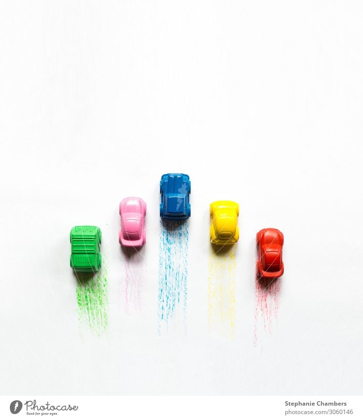 Five coloured crayon cars with colour trails. Car Multicoloured Motor vehicle colourful flatlay Zoom effect Crayon Colour photo