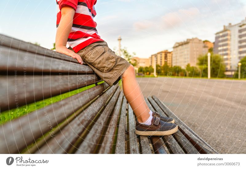Boy legs sitting on the top of bench park relaxing Lifestyle Beautiful Relaxation Summer Garden Child Human being Boy (child) Infancy Feet Nature Park Pants