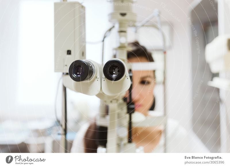 young woman sitting at Ophthalmologist clinic Healthy Health care Medical treatment Illness Medication Examinations and Tests Work and employment Profession