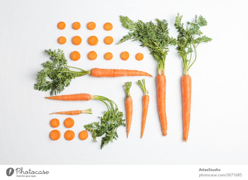 Flat lay composition with ripe fresh carrots on white background autumn cut slice table space orange agriculture vegetarian pieces isolated cutting juicy