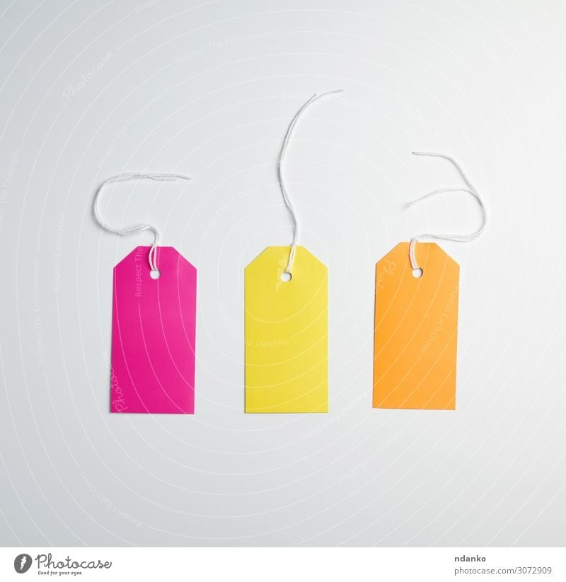 three colored paper tags on a white rope Shopping Craft (trade) Business Rope Paper Packaging String Hang Sell Natural Above Brown Yellow Pink White Promotion