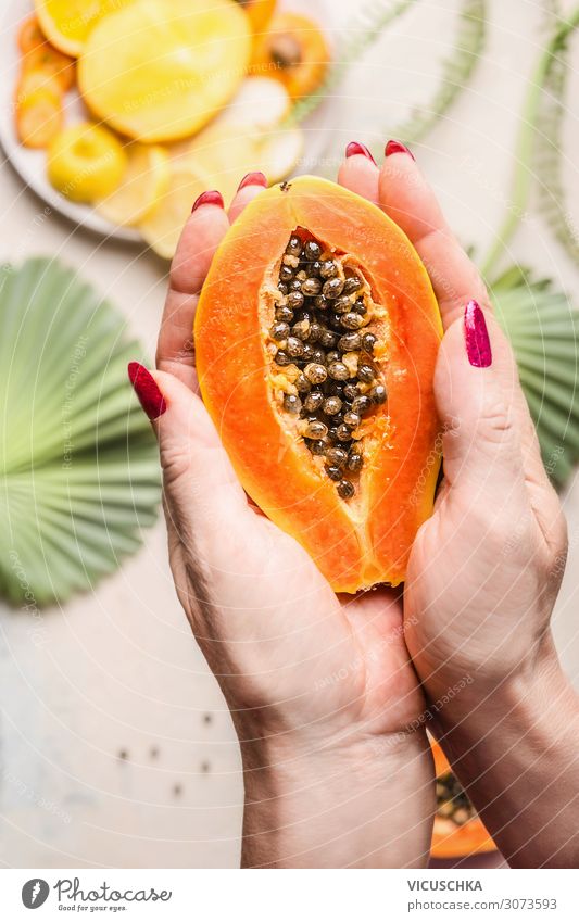 Women's hands hold half papaya with seeds Food Fruit Nutrition Breakfast Organic produce Vegetarian diet Diet Design Healthy Eating Woman Adults Hand Papaya