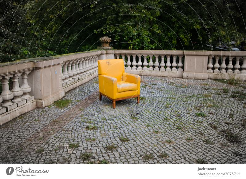Drop on lost upholstered chair lost places Environment Deciduous tree Neukölln Terrace rail Stone floor Paving stone Armchair Yellow Design Uniqueness Quality