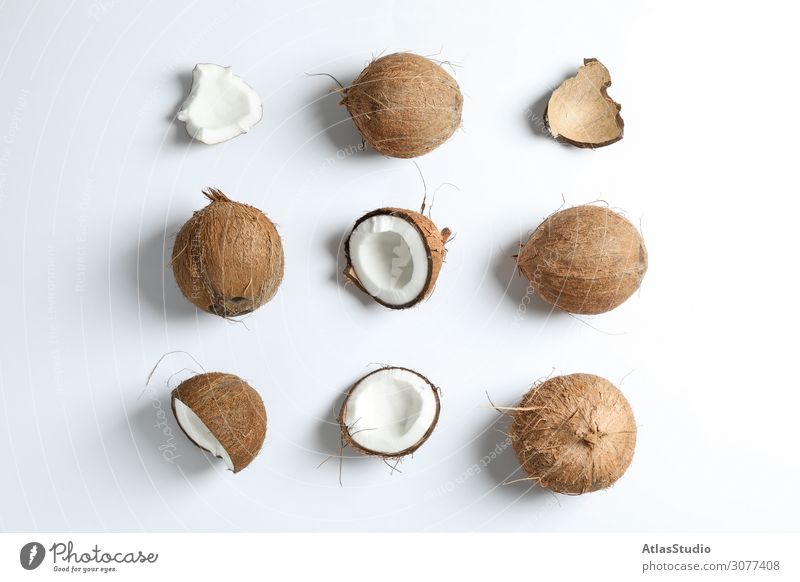 Flat lay composition with coconuts on white background half color tone cut leaf two eat modern palm vegetarian magazine ripe broken horizontal cocktail view