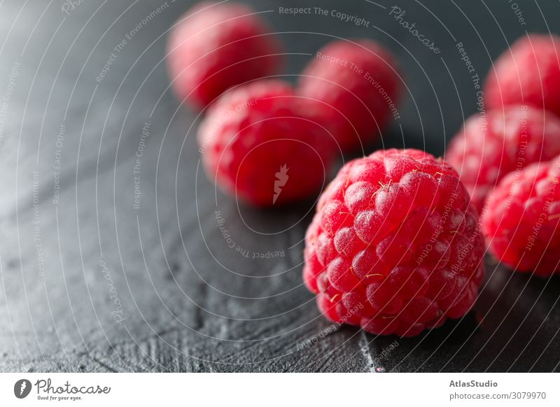 Raspberries on black cement background, closeup and space for text dry natural nature sweet abstract table red summer delicious macro backdrop ripe fruits