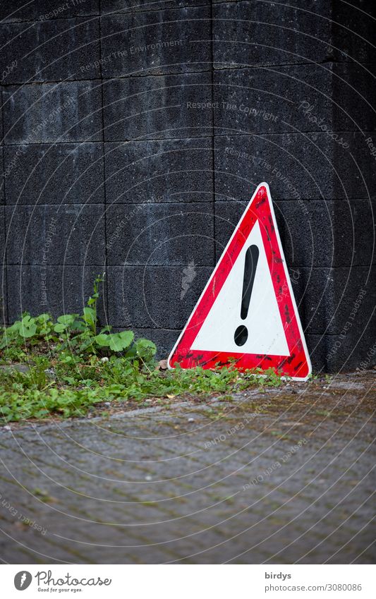 General danger spot, road sign 101 leaning against a wall general danger area Road sign peril Traffic sign 101 Foliage plant Wall (barrier) Wall (building) Sign