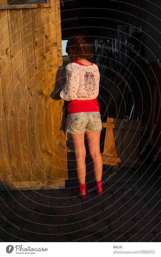 Young woman looks into a dark stable. Human being Feminine girl Youth (Young adults) Infancy House (Residential Structure) hut built door Looking Stand Dream