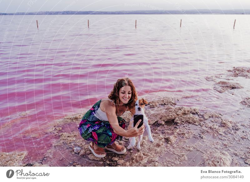 young beautiful woman standing by a pink lake with dog Lifestyle Joy Happy Beautiful Relaxation Leisure and hobbies Vacation & Travel Tourism Summer Beach Ocean