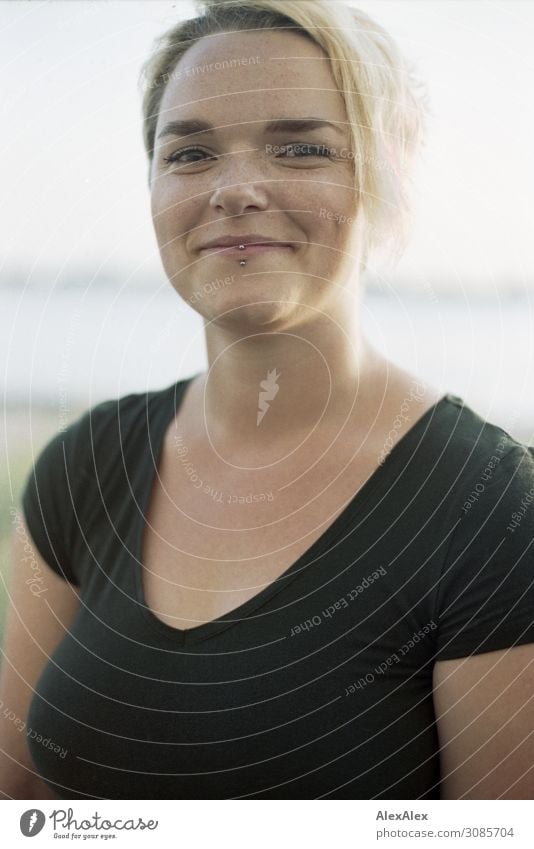 Portrait of a smiling young woman in black top in front of the river Elbe Lifestyle Joy pretty Well-being Young woman Youth (Young adults) pit 18 - 30 years