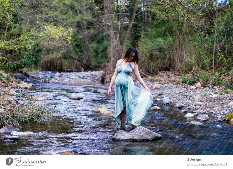 Pregnant girl posing near the river wearing a green dress. Lifestyle Style Joy Happy Beautiful Relaxation Freedom Summer Ocean Human being Feminine Young woman