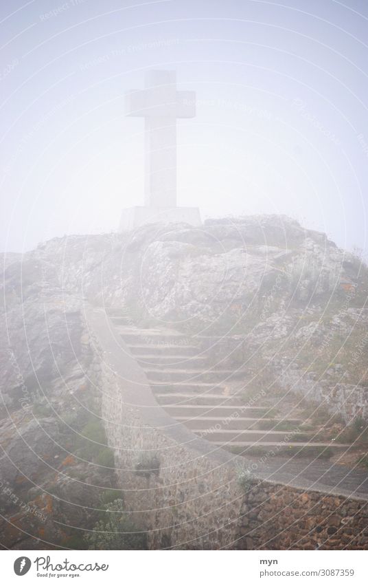 Celtic or Christian cross in the fog on a hill with stairs by the sea Crucifix Fog Stairs Grief Death Christianity Religion and faith Belief Shroud of fog