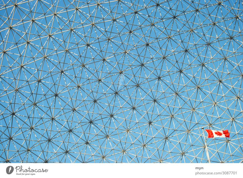 Biosphere building of the 1967 World's Fair in Montreal Canada with flag Net Pattern Grid Manmade structures Network Steel construction Interlaced